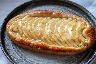 French fresh baked sweet puff pastry with fresh apple fruits in sirup in confectionery shop