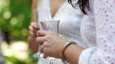 women in white dresses with glasses of champagne. Bachelorette party.