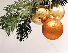 Three Christmas decorations hanging from a tree