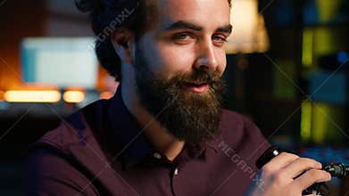 Portrait of jolly media star telling viewers facts about himself, close up