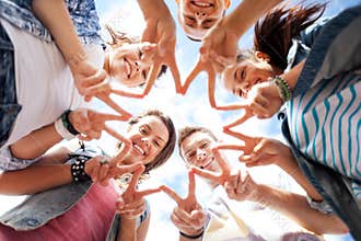 Group of teenagers showing finger five
