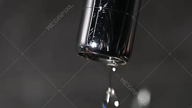 leaking faucet. dripping tap. water drops falling from faucet, extreme close up