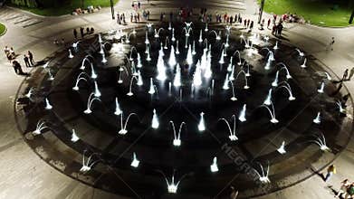 Look down aerial on fountain in night illumination