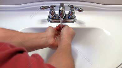 Man washes hands