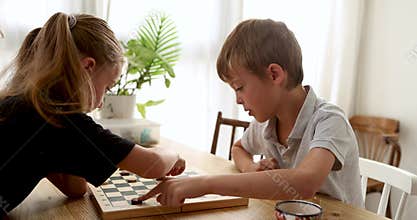 Engaging moments of children playing chess together at home