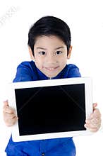 Little asian cute boy smiles with tablet computer on isolated ba