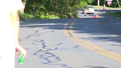 Triathlon runners pass water station; 20