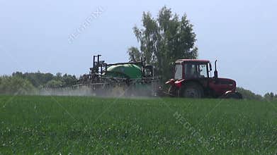 Agriculture tractor spraying crop wheat field