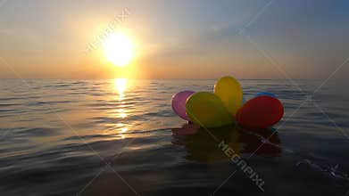 Bunch airy multi-colored balloons swing waves sea sunny summer day sunset Dawn