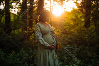 Portrait Of Fairy Pregnant Woman In Wild Forest At Sunset, Golden Hour