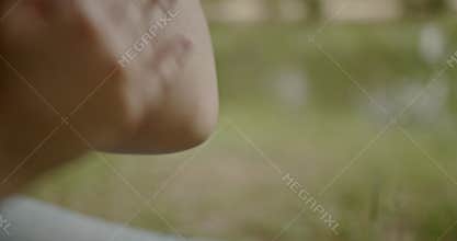 Woman Scratches Itchy Arm Outdoors: Allergies, Insect Bites, and Skin Irritation