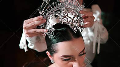 Elegant woman being crowned with a tiara, symbolizing achievement or royalty