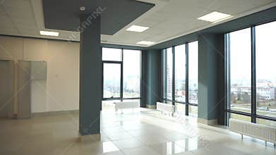 View of an empty spacious hall with columns and panoramic windows. Modern interior design of an empty office.