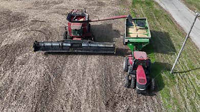 combine unloading corn into grain wagon at harvest time