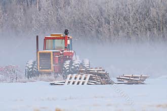 Tractor in the field on a cold frosty Alberta morning
