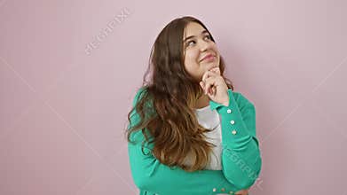 Thoughtful young hispanic woman with a beautiful smile, standing in doubt over a question. pensive face, hand on chin, isolated on