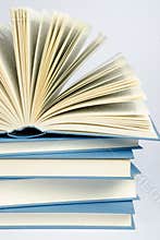 A stack of blue books on light blue background