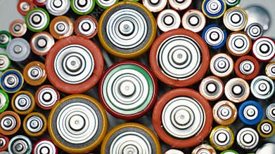 Top view of a group of used AA, AAA, D batteries. Alkaline batteries