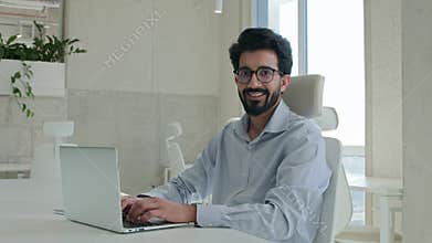 Arabian Indian muslim businessman ethnic man working with computer at corporate office cheerful happy manager employee
