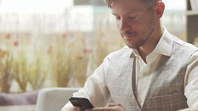 Businessman sitting and working in a cafe. Man using devices. Business and entrepreneurship concept.