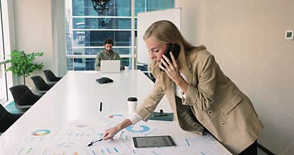 Financial analyst preparing report talk on smartphone in boardroom