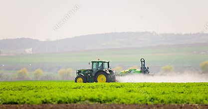 Sustainable farming agriculture, tractor take care of crops in a farming field, cultivating fields