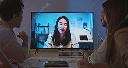Asian businesspeople in team meeting, online video conference call on ESG at night