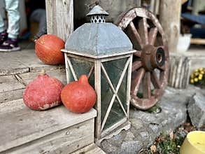 Pumpkins and lantern near house. Selective focus