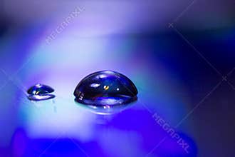 Two drops of water on a CD, illuminated by artificial light. It was made in a studio in Szirák.