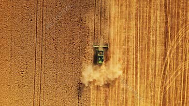 Combine Harvesting A Crop Field on Hot Dry Summer Day Agriculture Descend Zoom