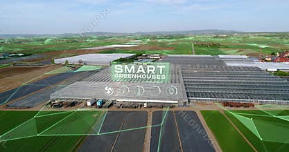 Concept of a large modern greenhouse. Moder greenhouses aerial view. Flight over a large greenhouse. Growing vegetables