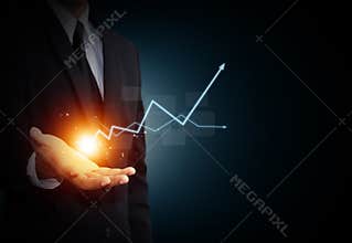 Hand holding a rising arrow