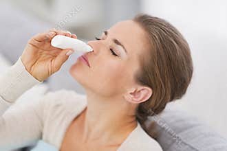 Woman using nasal drops