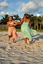 Girls dancing on sand at beach