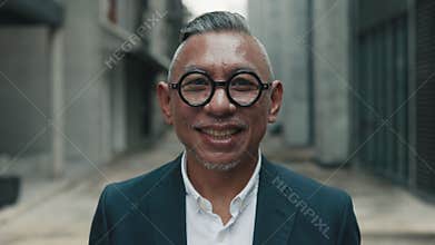 Positive Asian Businessman Smiling Near Office Center