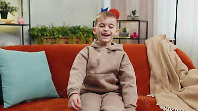 Child boy laughing out loud after hearing ridiculous anecdote, funny joke, feeling carefree amused