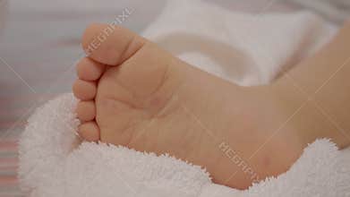 Child shows chickenpox blisters and rash on sole of foot in a home setting