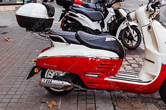 Barcelona, Spainâ€”January 15, 2026. Red and white peugeot django scooter parked on street