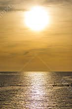 Big sun above the silky ocean surface