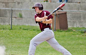Handsome Young Teen Baseball Player Swinging the Bat