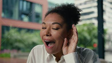 Portrait amazed excited African American business woman listening gossip news holding palm near ear businesswoman wonder