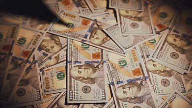 Closeup pile of one hundred American dollars on table dark room banknotes fall onto stack money. High interest rates on