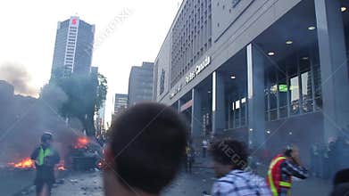Chaotic riot scene with fire and tear gas bombs