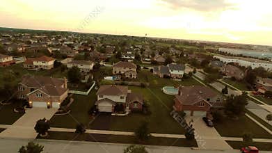 Aerial view houses in residential suburban neighborhood with backyard landscape and rooftops