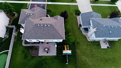 Aerial view houses in residential suburban neighborhood with backyard landscape and rooftops