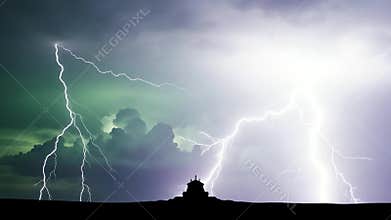 Dramatic Lightning Strikes Illuminate Stormy Night Sky Over Silhouetted Landscape