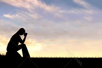 Woman Sitting Down in Prayer Silhouette