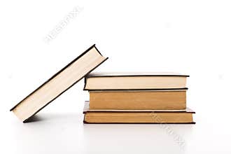 Stacked books showcasing different colors and sizes on a plain background