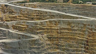 Aerial of open mine and heavy mining equipment