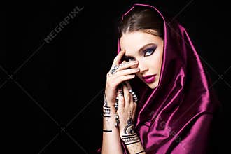 Beautiful woman in oriental style with mehendi